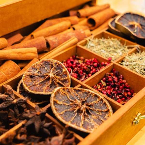 pexels-photo-29172136 A wooden box filled with assorted spices and dried citrus slices, showcasing natural flavors.