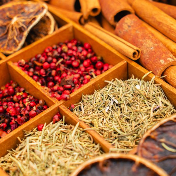 pexels-photo-29172138 A vibrant display of dried spices and herbs including cinnamon, peppercorns, and rosemary.