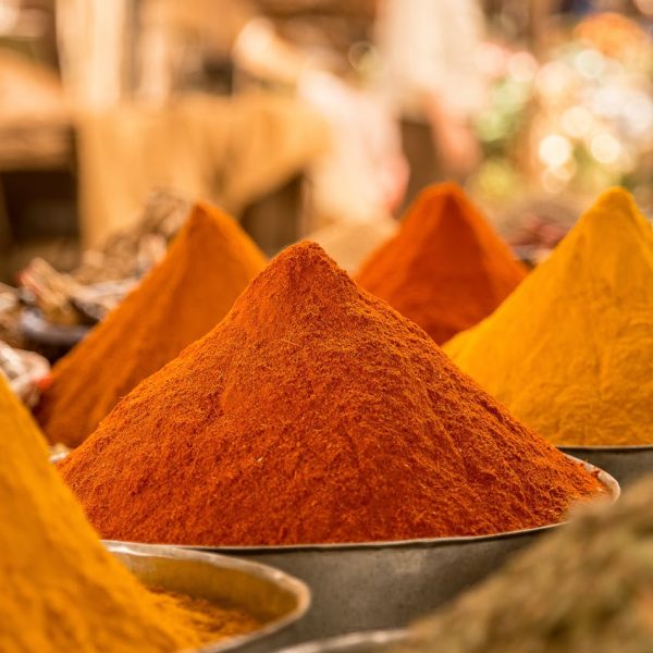 pexels-photo-5504609 A close-up view of colorful powdered spices on display at a market stall.